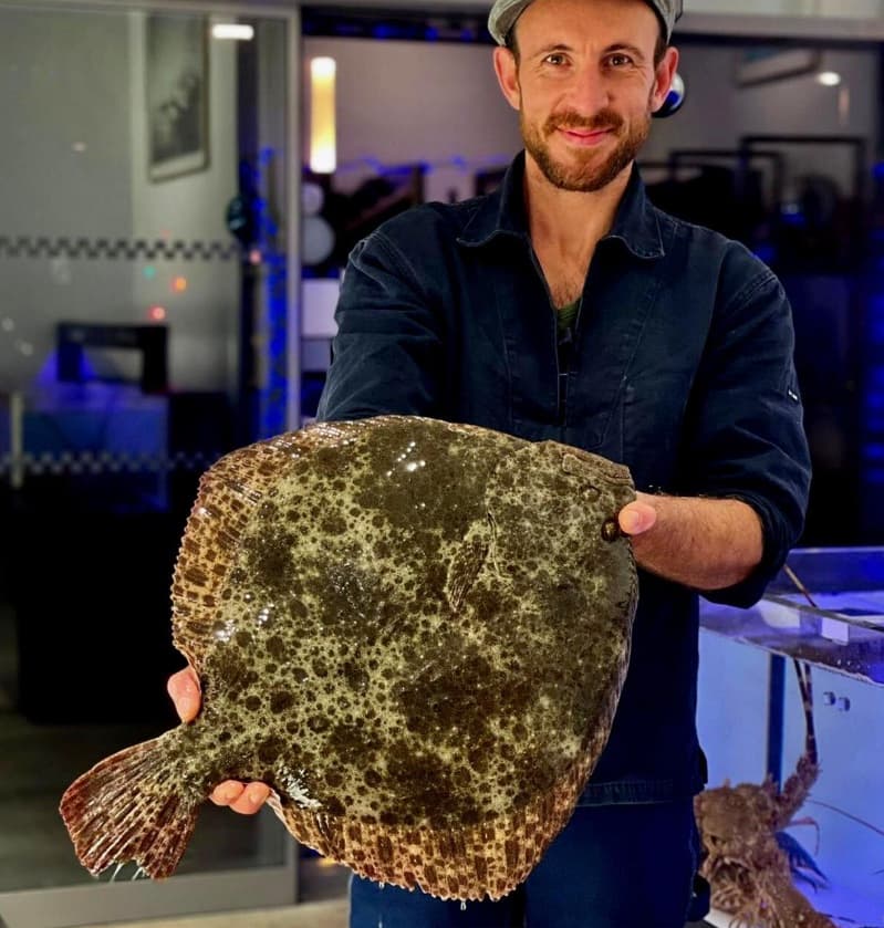 Pierre holding up a whole turbot